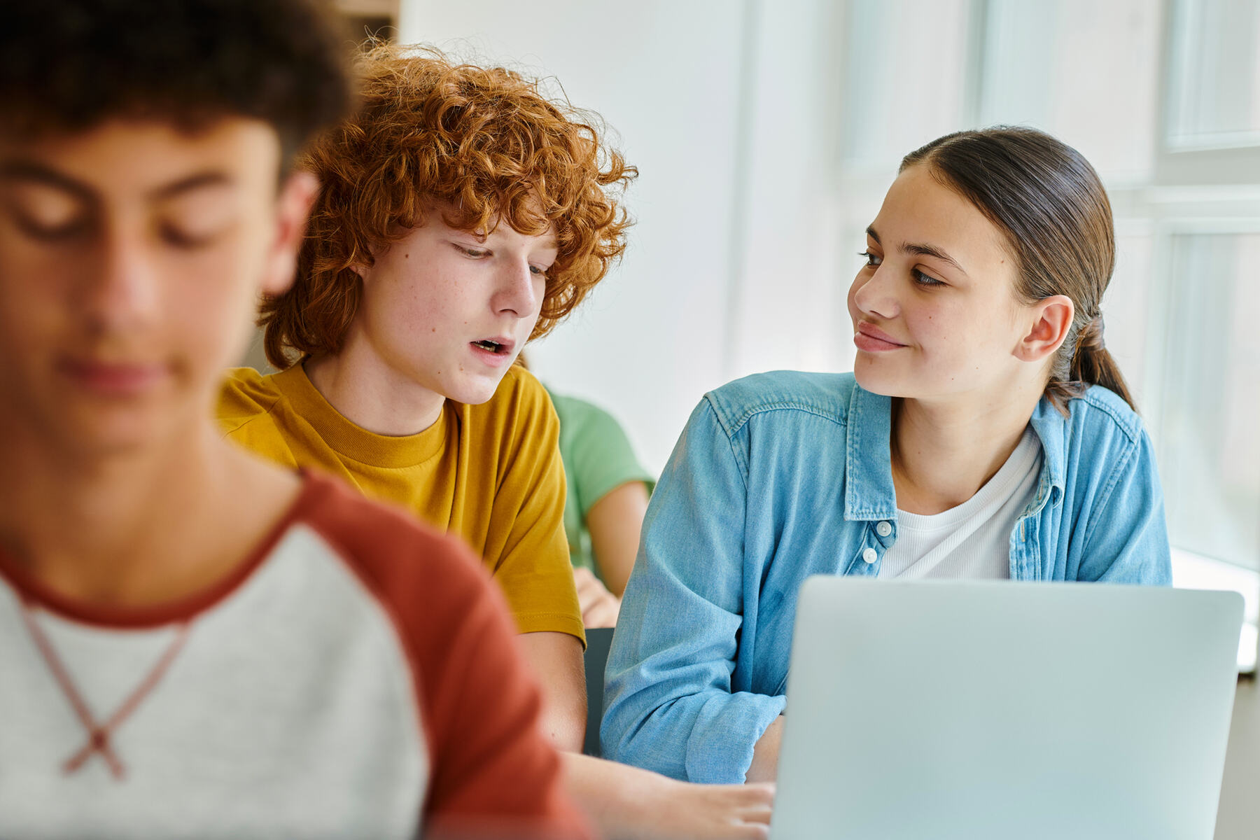 Middle school students working on laptops